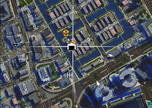 an aerial view of a city with a mouse pointer pointing to a house