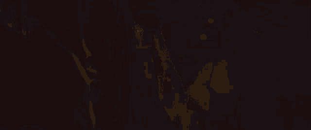 a close up of a woman 's face in a dark room with a reflection of her face in a mirror .