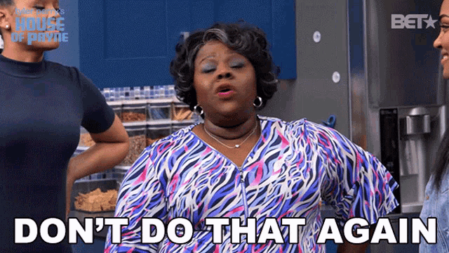 a woman says " do n't do that again " while standing in front of a refrigerator