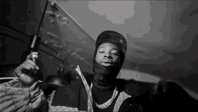 a black and white photo of a man in a ski mask