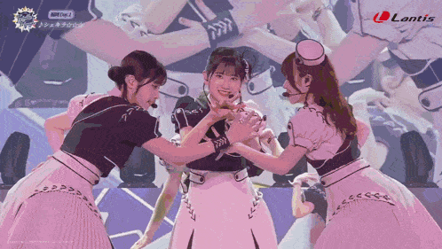 a group of girls are performing on a stage with lantis written on the bottom