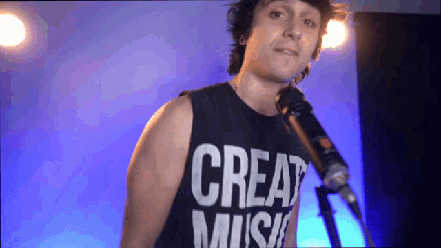 a man singing into a microphone with a shirt that says great music