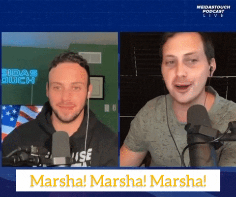 two men are sitting in front of microphones and a sign that says marsha
