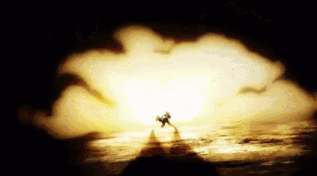 a person is standing in front of a large explosion in the dark
