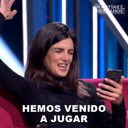 a woman sitting on a couch looking at her phone with the words hemos venido a jugar