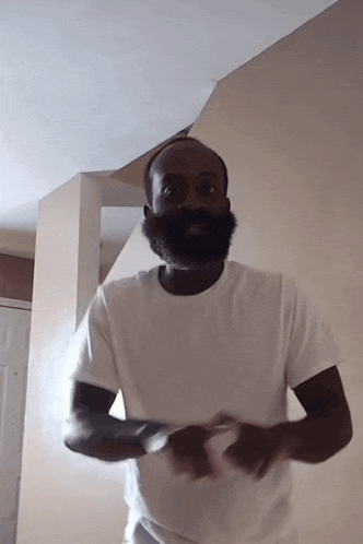 a man with a beard wearing a white t-shirt