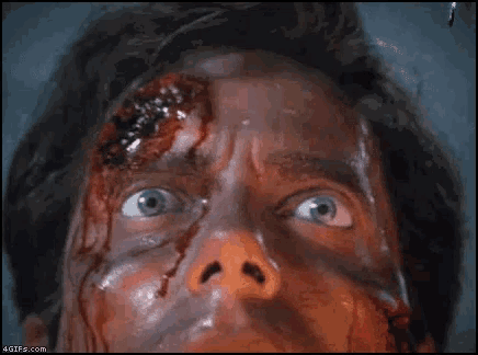 a close up of a man with blood on his face