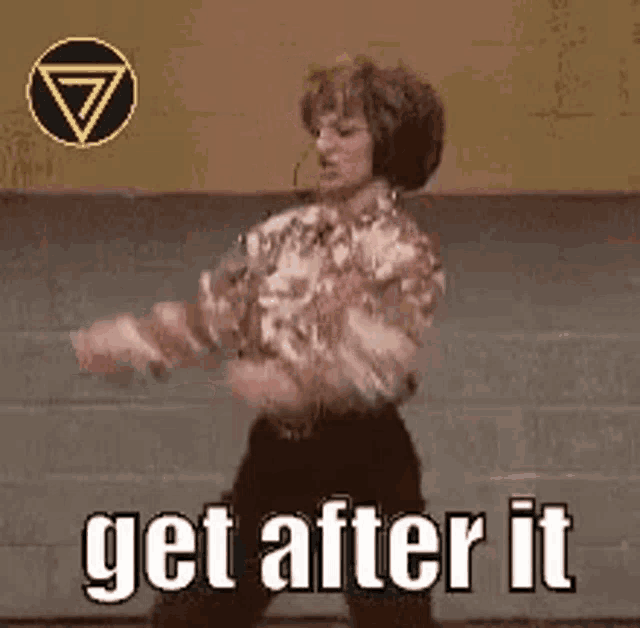a woman is dancing on a stage with the words `` get after it '' written below her .
