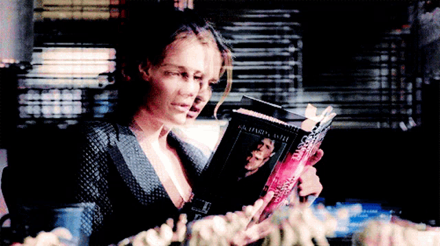 a woman is reading a book called always alone
