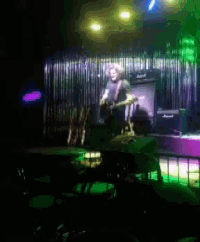 a blurry picture of a man playing a guitar on stage