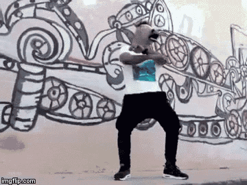 a man is standing in front of a wall with a drawing on it .