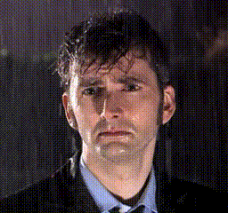 a man in a suit and tie is looking at the camera with a sad look on his face