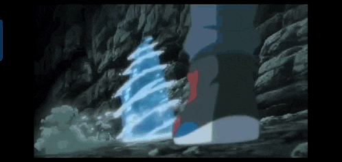 a person is standing in front of a waterfall in a dark cave .