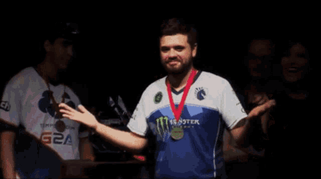 a man wearing a monster shirt is waving his hand