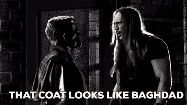 a black and white photo of two men standing next to each other and the caption that coat looks like baghdad