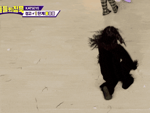a woman with curly hair is laying on her back on the floor