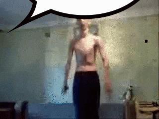 a man without a shirt is standing in a room with a speech bubble behind him