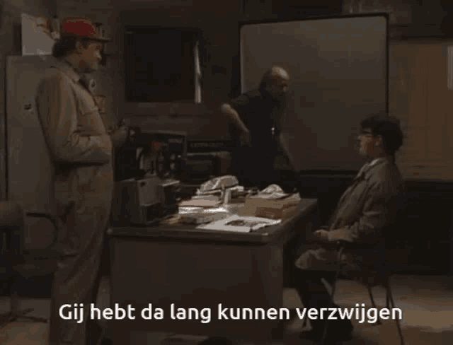 a man in a red hat is holding a steering wheel and says gij hebt da lang kunnen verzwijen