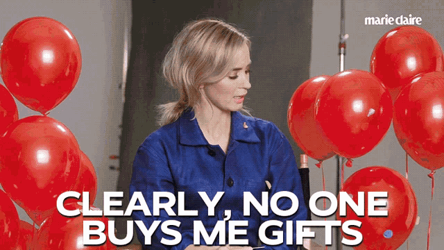 a woman is surrounded by red balloons and the words clearly no one buys me gifts