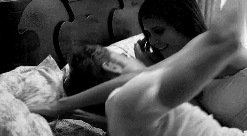 a man and a woman are laying on a bed .