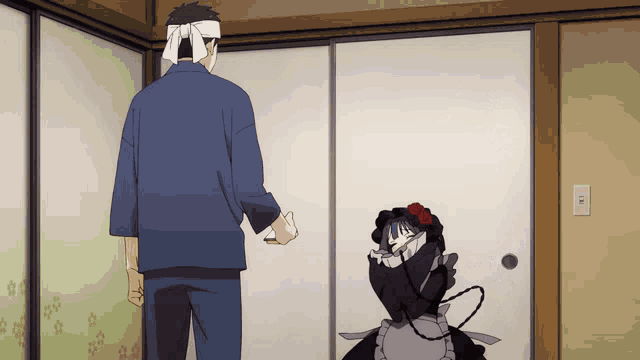 a man with a bandana on his head stands next to a woman in a maid costume
