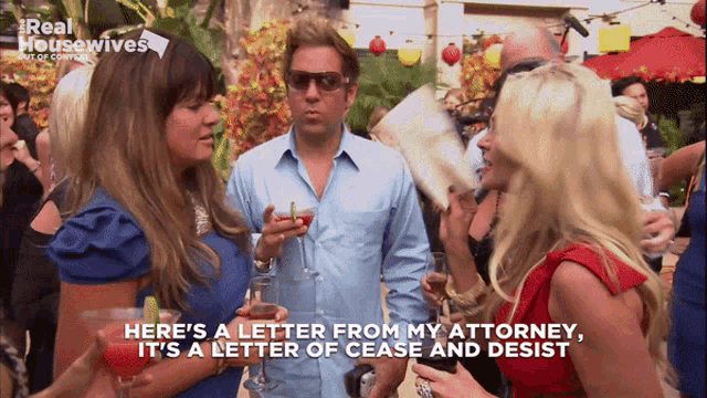 a group of people are gathered in front of a sign that reads real housewives