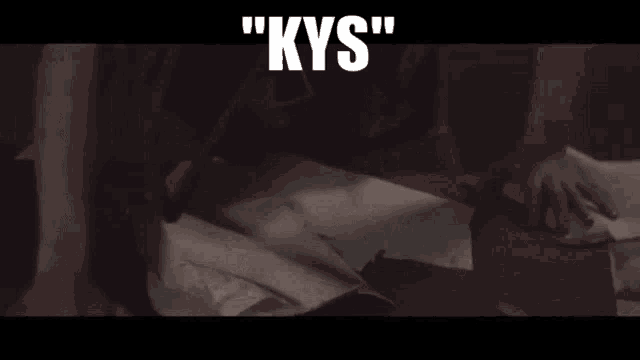 a man is writing on a piece of paper with the words " kys " written above him