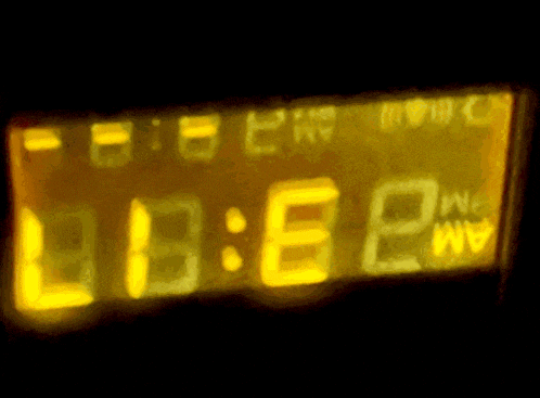 a digital clock displays the time of 13:58