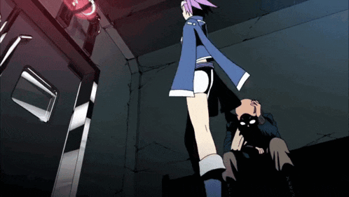 a girl in a blue jacket is standing next to a man in a dark room