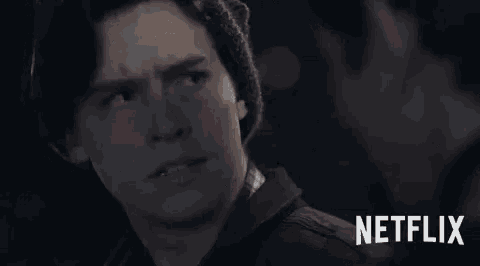 a man is looking at another man 's face in a netflix ad .