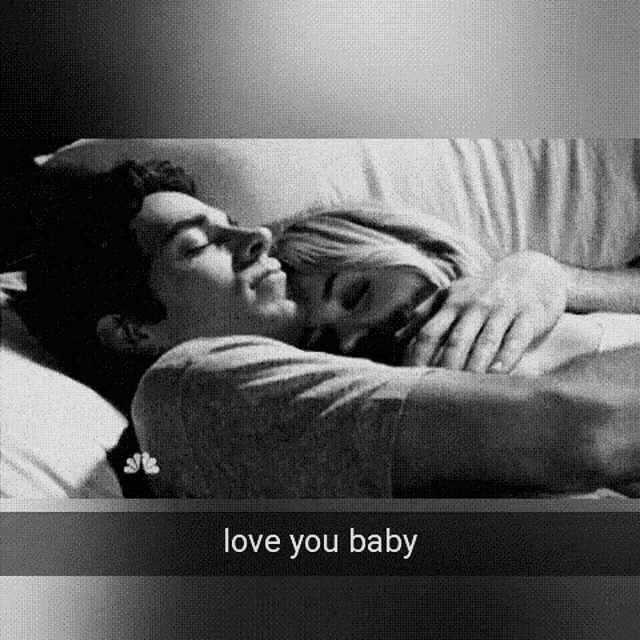 a black and white photo of a man and a woman hugging each other .