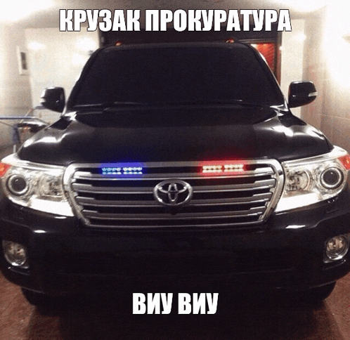 a black toyota suv with russian writing on the hood