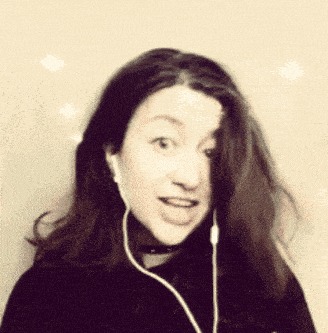 a woman wearing a choker and ear buds looks at the camera