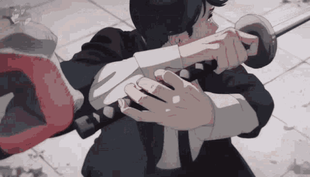 a man in a suit is holding a sword in his hands while fighting another man .