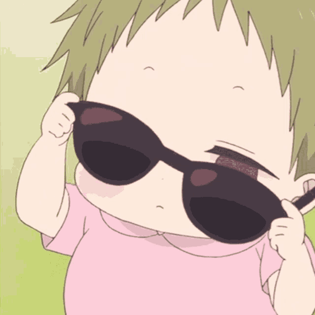 a baby wearing sunglasses and a pink shirt is looking down