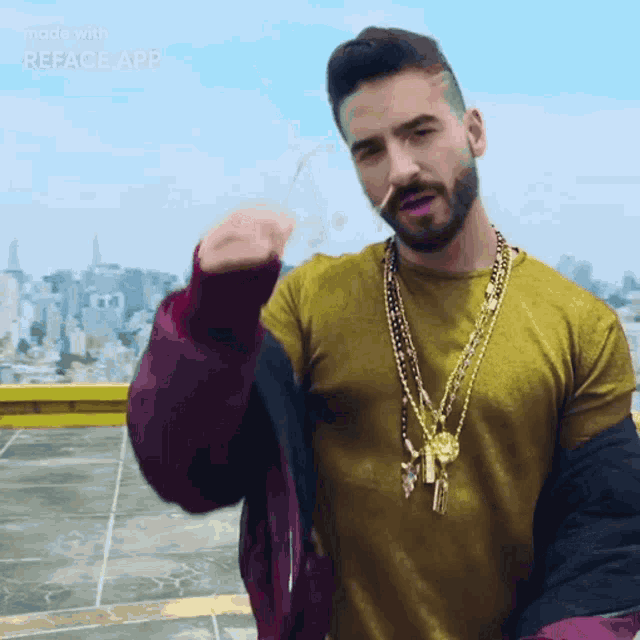 a man with a beard is wearing sunglasses and a gold chain around his neck ..