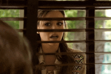 a woman looking through a window with milkylatte written on the bottom right corner