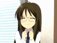 a girl with long brown hair and glasses is smiling with her hands in front of her face .