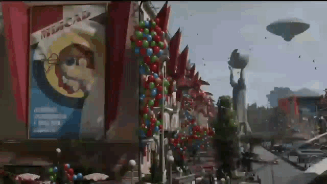 a city street is decorated with balloons and a sign that says welcome