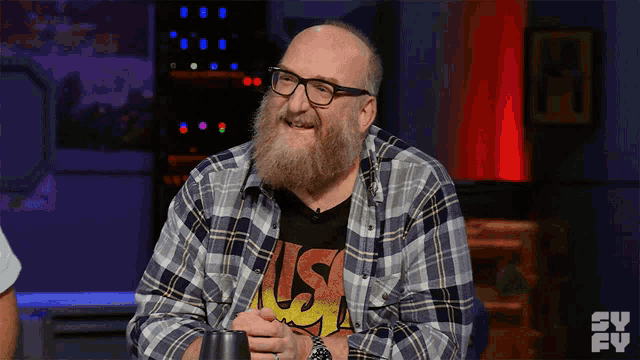 a man with a beard wears a shirt that says us on it