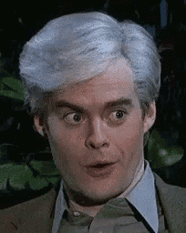 a man with gray hair is making a funny face .