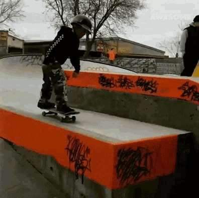 a young boy is riding a skateboard on a ramp that has graffiti on it and the word awesome on the bottom