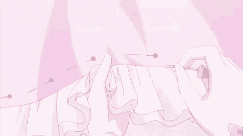 a person is sewing a pink dress with a needle .