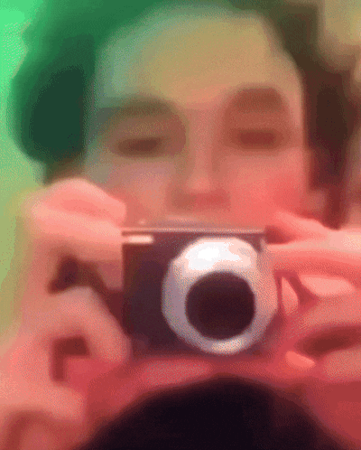 a person is taking a picture of themselves with a small camera