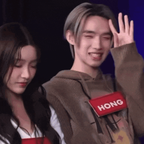 a man and a woman are standing next to each other and the man is wearing a hong shirt