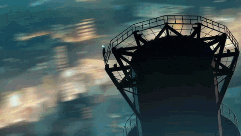 a silhouette of a person standing on top of a very tall building