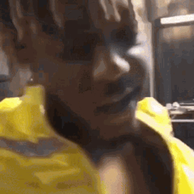 a close up of a person wearing a yellow jacket