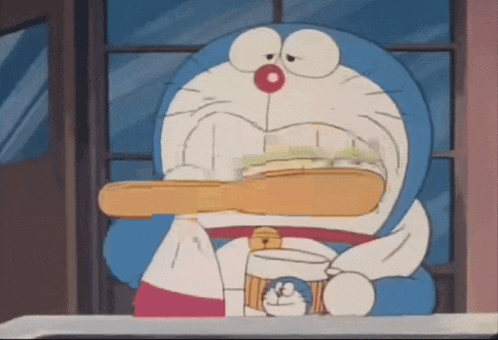 doraemon is brushing his teeth with a toothbrush