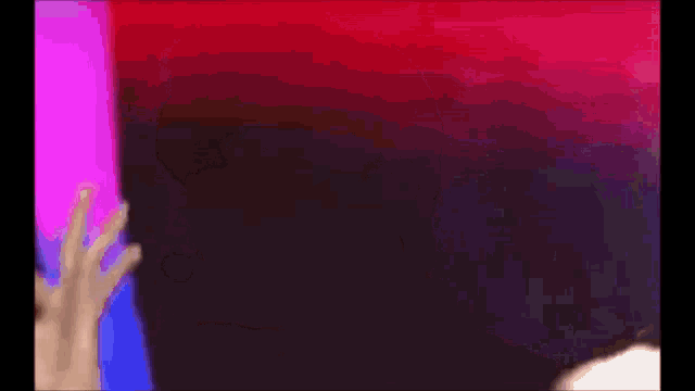 a purple and red background with a silhouette of a person in the foreground