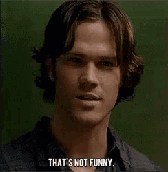 a man is smiling and says that 's not funny